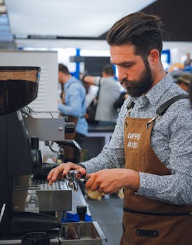 A focused barista making espresso at a bustling café. Ideal for business and coffee themes.